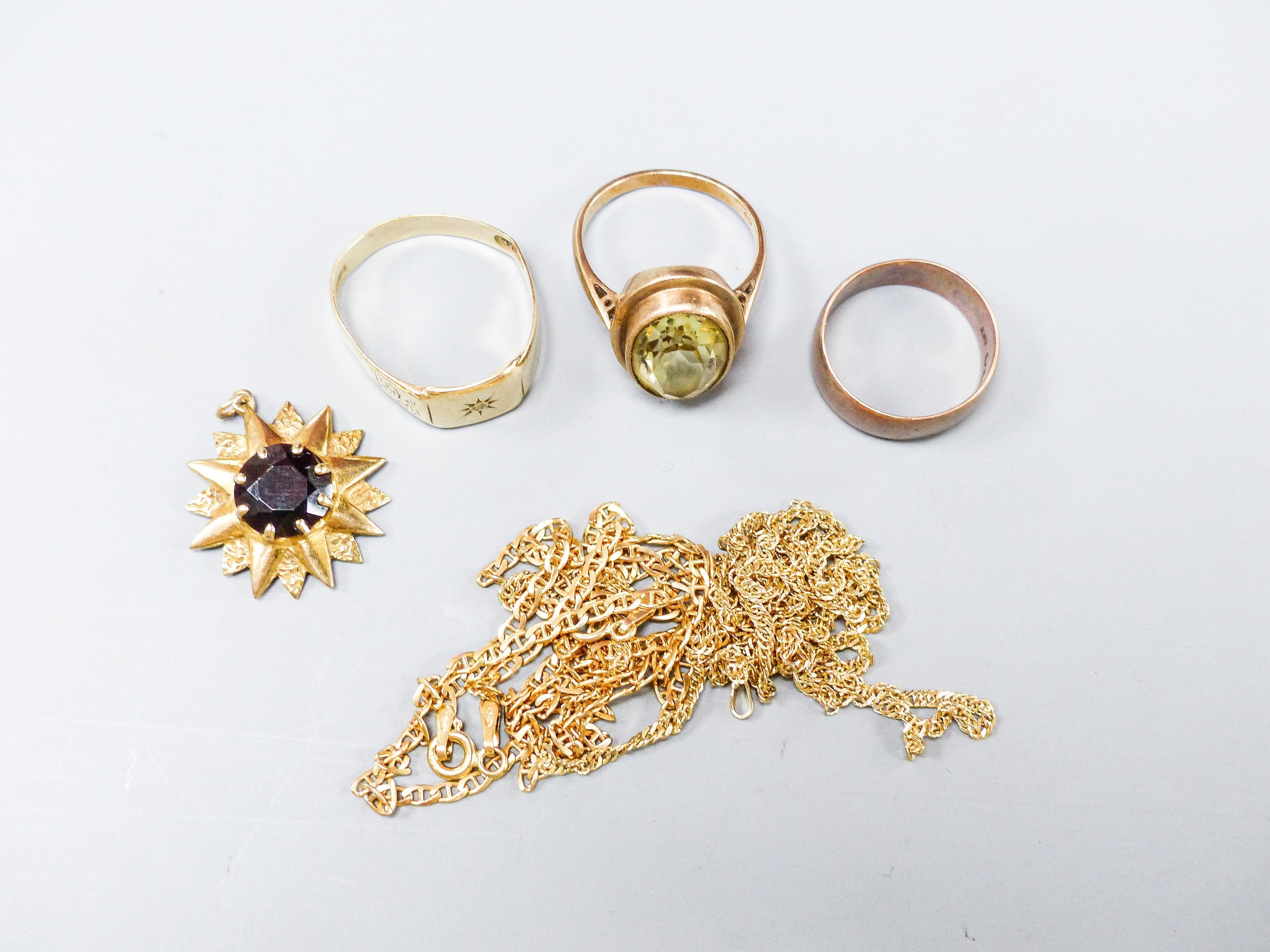 Three 9ct gold rings, two 9ct gold chains and a 9ct gem set pendant, gross weight 21.1 grams.